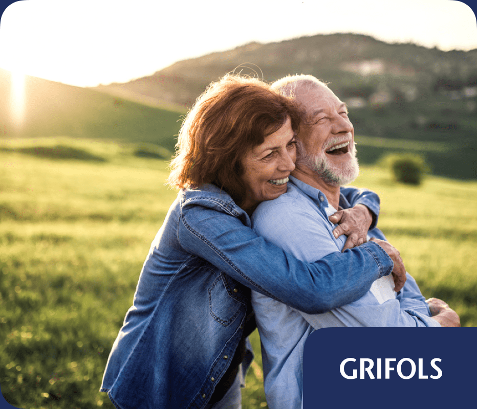 Couple embracing outdoors representing health and wellness, with Grifols branding